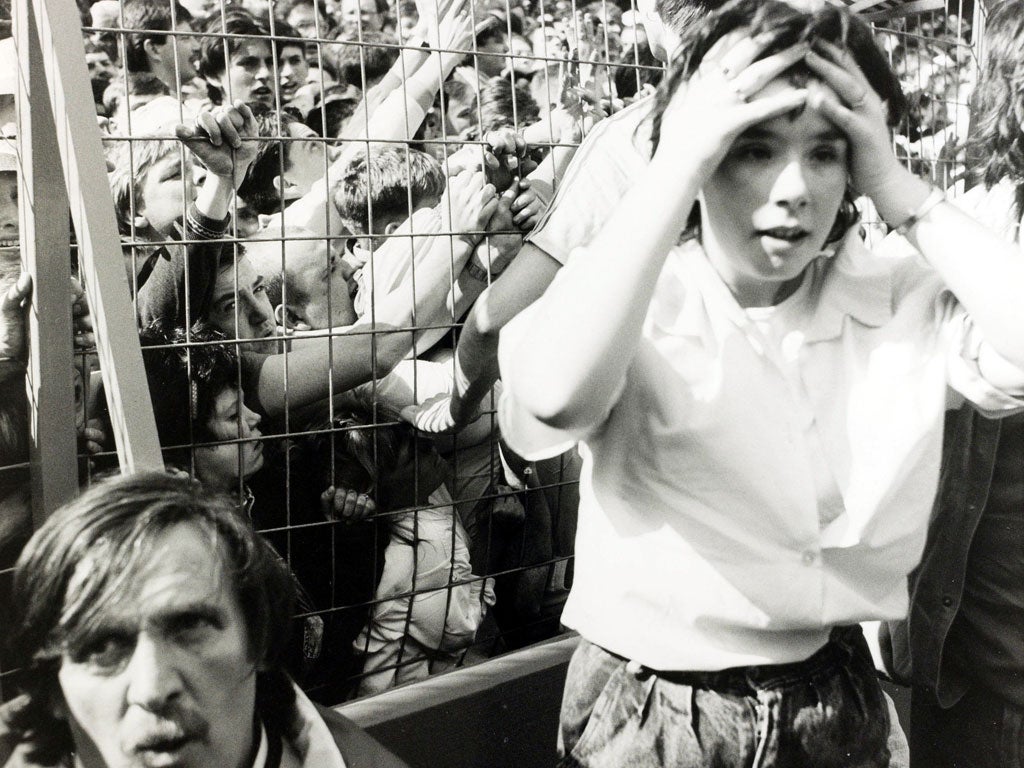 Penned in: A Liverpool fan is horrified as fans behind the fence try to escape the crush