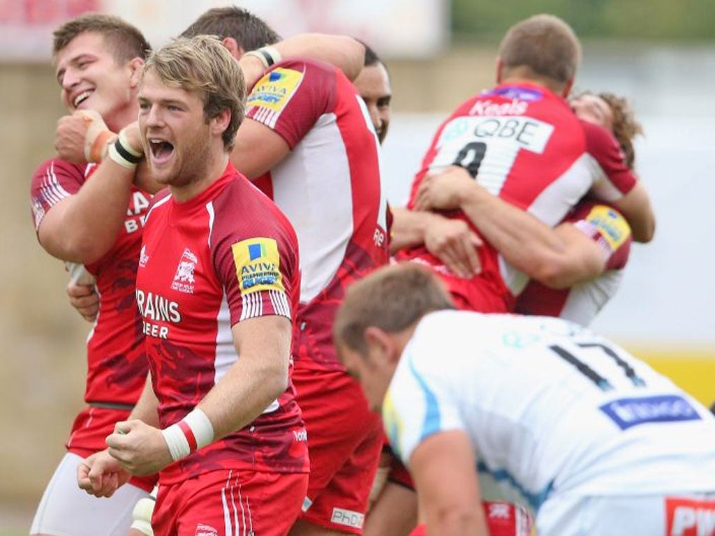 London Welsh’s players celebrate their late victory over Exeter yesterday