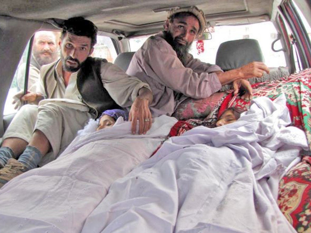 Relatives accompany the bodies of Afghan women reportedly killed in a Nato airstrike in Laghman Province as they collected wood
