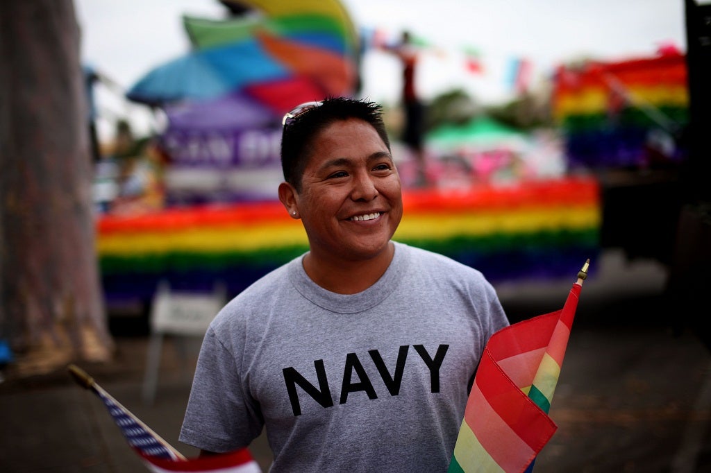 Joseph Martinez, an active duty sailor in the Navy, prepares to march during the San Diego gay pride parade July 16, 2011