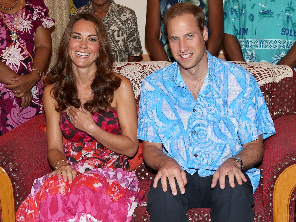 Catherine, Duchess of Cambridge and Prince William, Duke of Cambridge pose wearing traditional island clothing during a visit to the Governor General's house as part of their Diamond Jubilee tour of the Far East
