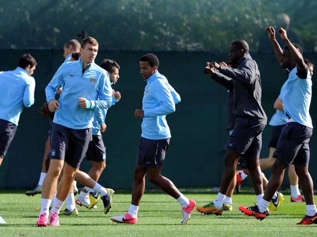 City’s Edin Dzeko (left) and his team-mates train in Manchester before flying to Madrid