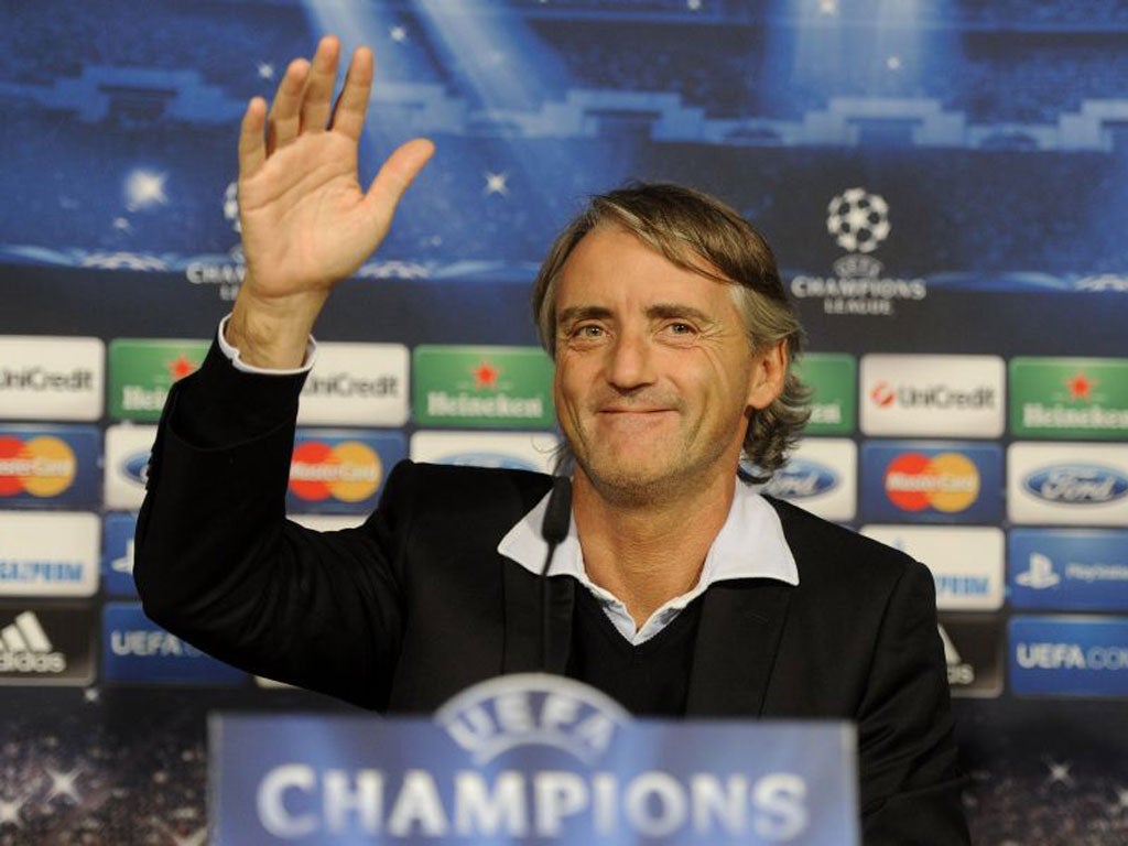 Roberto Mancini gestures during a news conference in Madrid