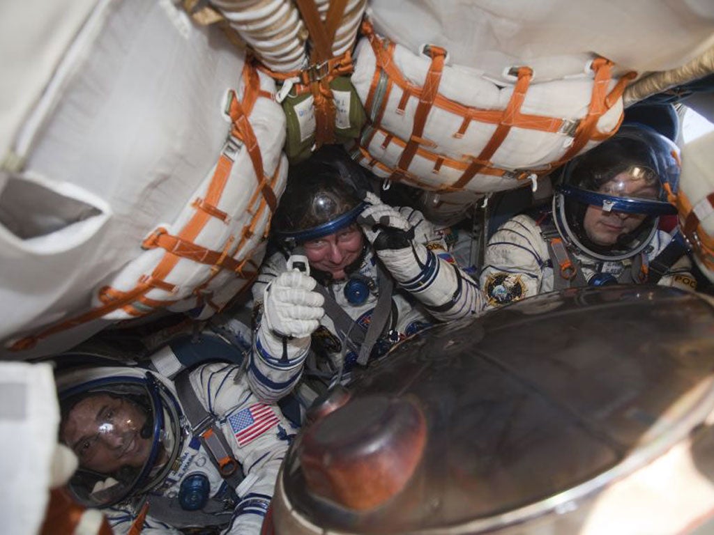 Joseph Acaba, Gennady Padalka and Sergei Revin tightly packed inside the capsule