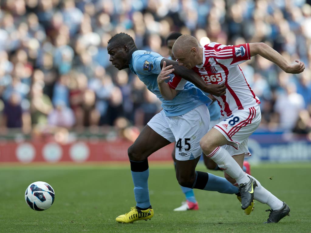 Andy Wilkinson vies with Mario Balotelli