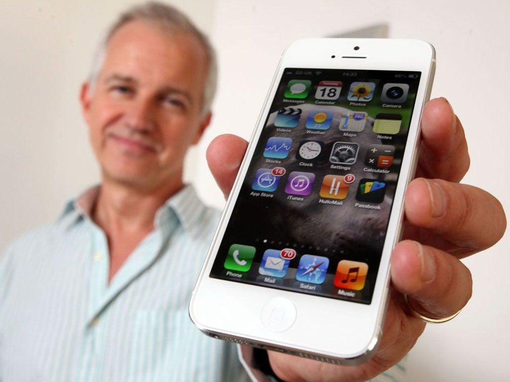 The Independent journalist David Phelan is pictured assessing the merits of the new Apple IPhone 5 4g phone in London