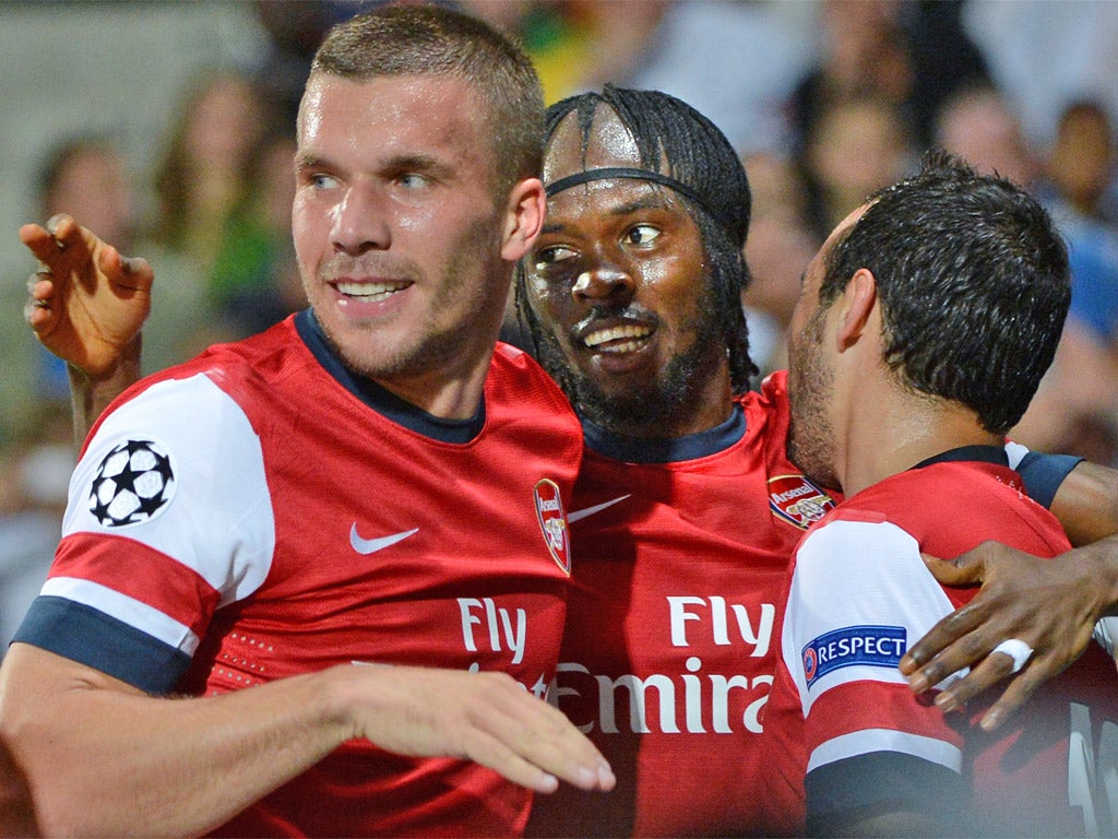Lukas Podolski, scorer of Arsenal's first goal, celebrates with Gervinho after the Ivorian put The Gunners ahead two minutes later