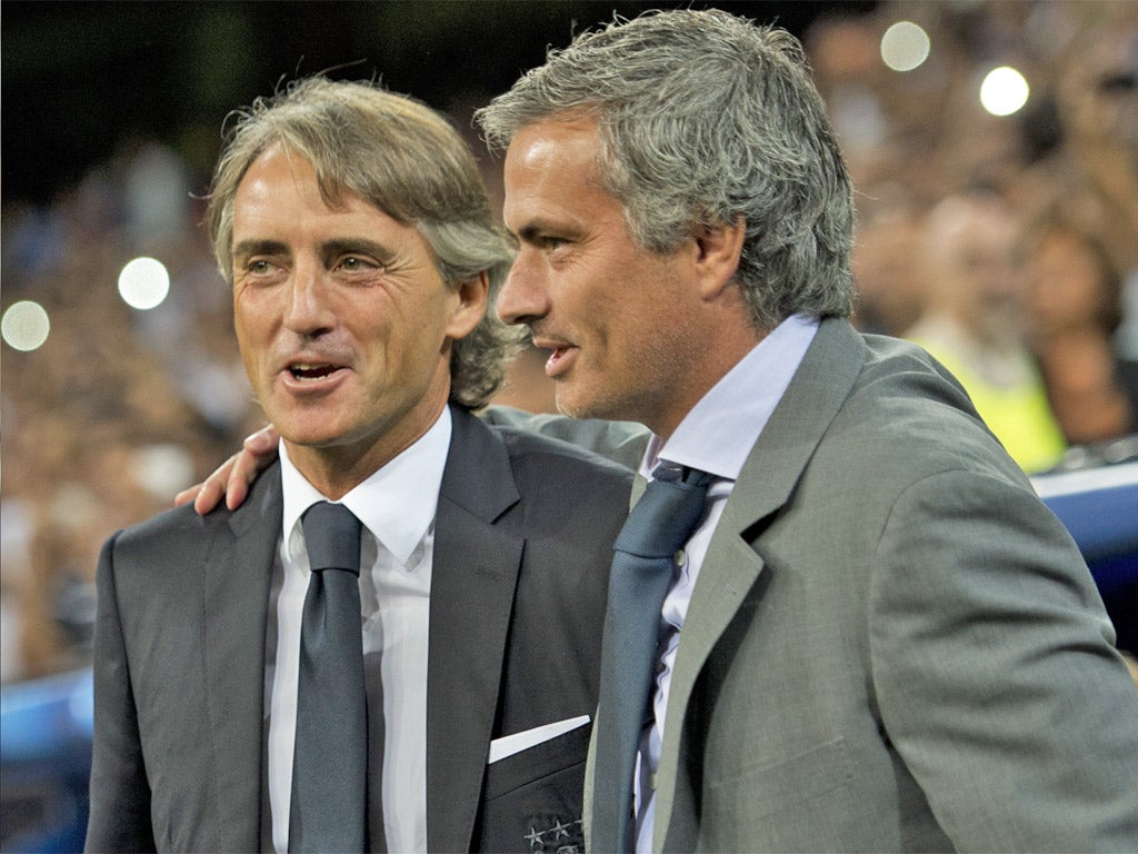 Roberto Mancini and Jose Mourinho share a joke during last night's game