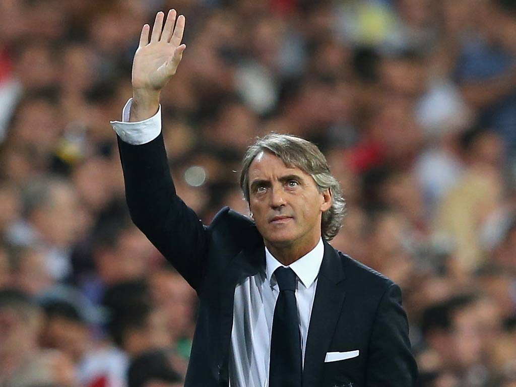Roberto Mancini waves to the Manchester City fans