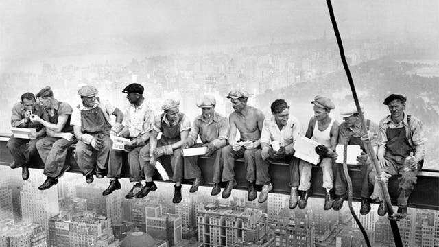 The 11 men sit eating lunch high above New York