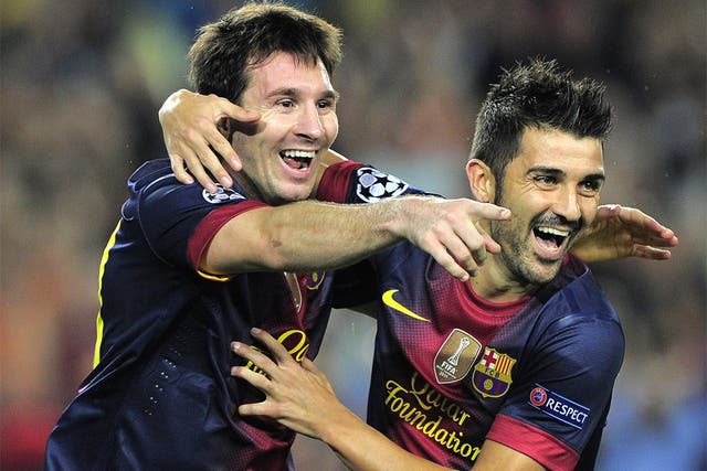 Lionel Messi is congratuled by his Barcelona teammate David Villa