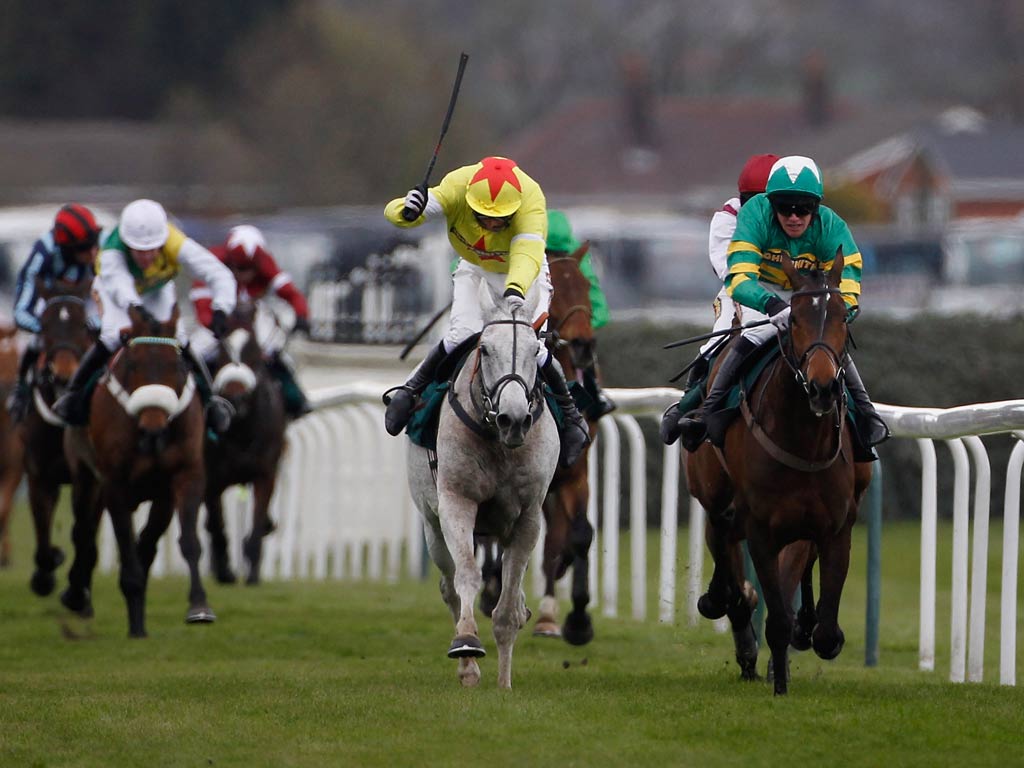 Daryl Jacob riding Neptune Collonges (grey horse) on their way to winning The John Smith's Grand National earlier this year