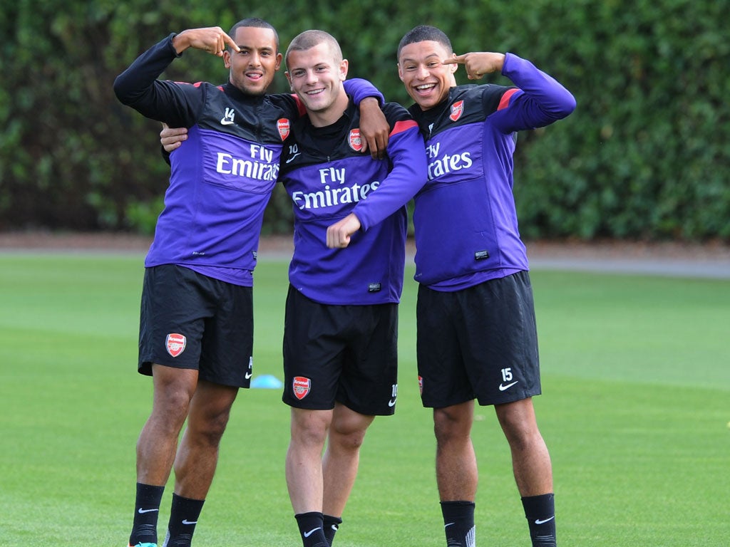Jack Wilshere is the centre of attention at training yesterday