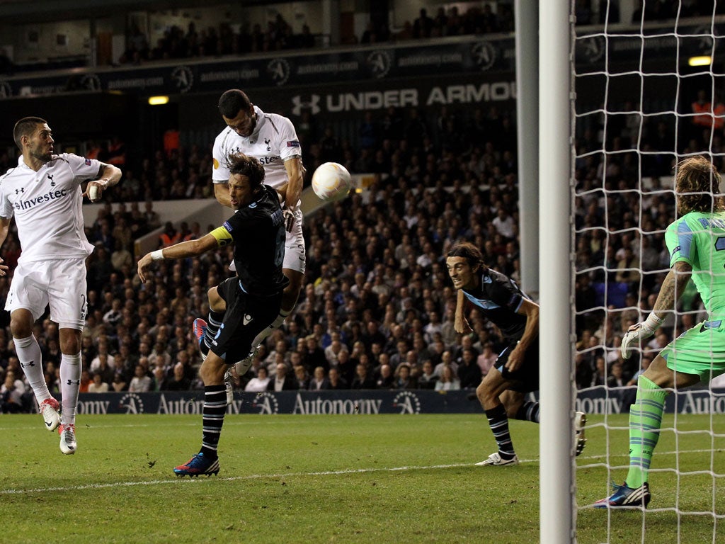 Tottenham's Steven Caulker rises above Stefano Mauri of Lazio to put the ball in the net, only for the goal to be disallowed by the referee