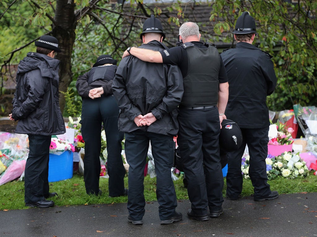 Police lay flowers near the scene of the shooting of PCs Nicola Hughes and Fiona Bone