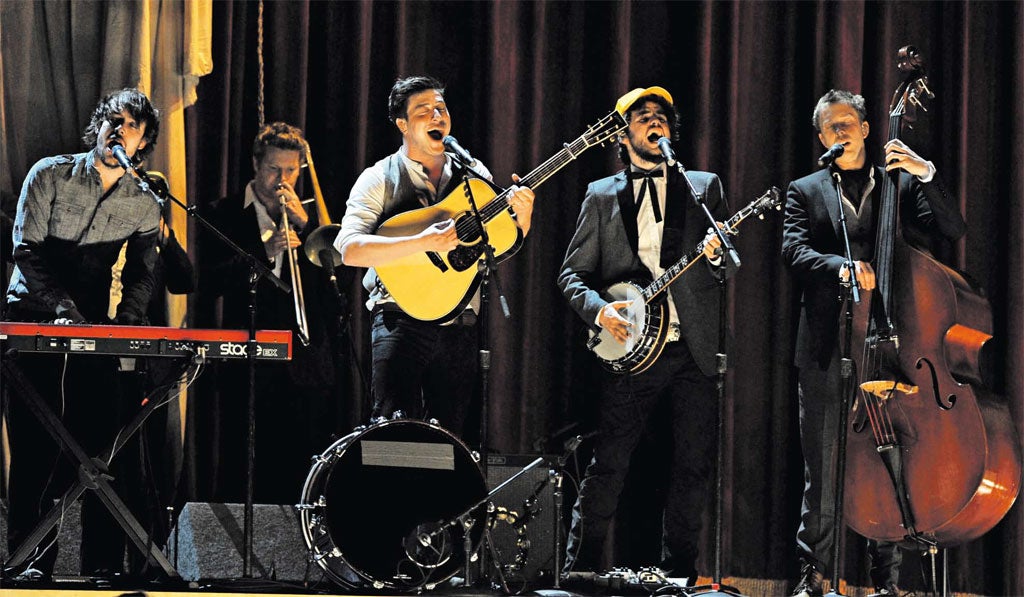 The high life: Ben Lovett, Marcus Mumford, Winston Marshall, and Ted Dwane of Mumford and Sons on stage during this year’s Grammy awards Awards in Los Angeles
