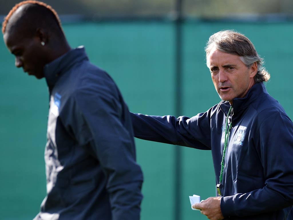 Mario Balotelli and Roberto Mancini pictured during a training session