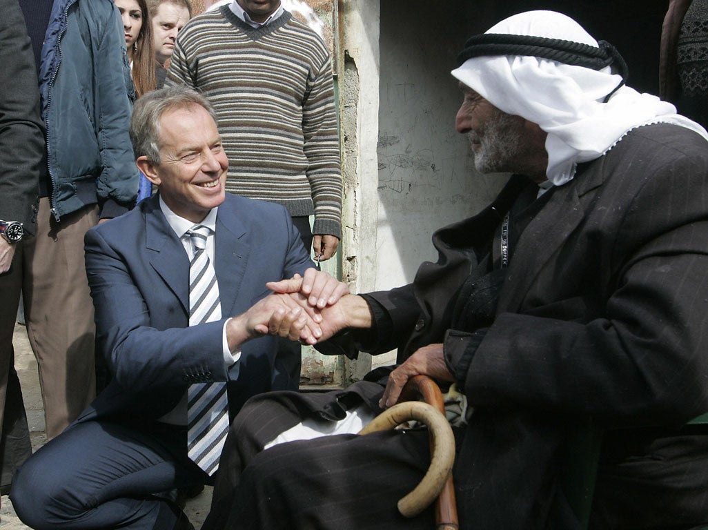 Former British prime minister and Middle East Quartet envoy Tony Blair (L) shakes hands with 100-year-old, March 19, 2009.