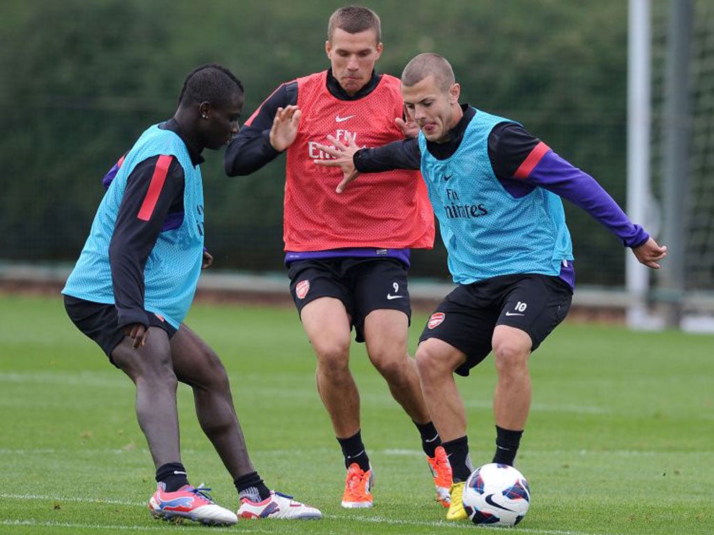 Jack Wilshere (right) eases back into training with Arsenal this week