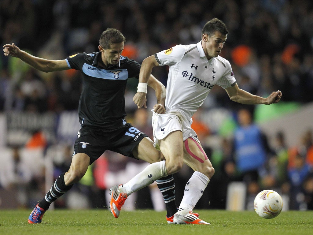 A bit of a handful: Gareth Bale (right) tries to hold off Lazio's Senad Lulic