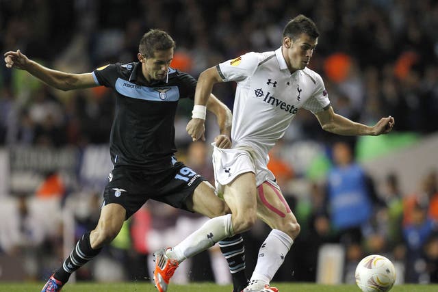 A bit of a handful: Gareth Bale (right) tries to hold off Lazio's Senad Lulic