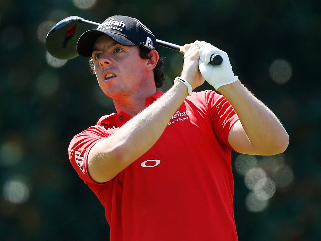 Red alert: Rory McIlroy watches his tee shot at the fifth hole yesterday
