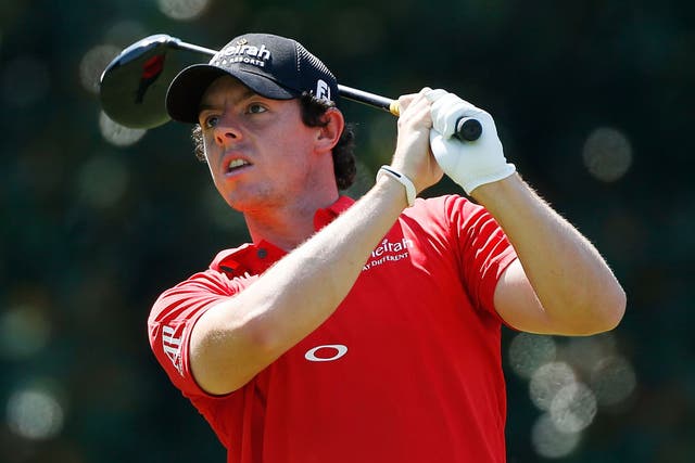 Red alert: Rory McIlroy watches his tee shot at the fifth hole yesterday