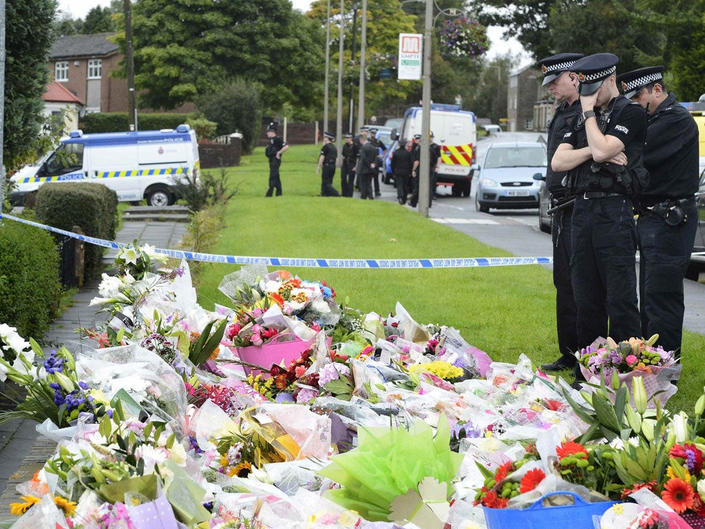 Police pay tribute to their murdered colleagues near the spot where they were shot