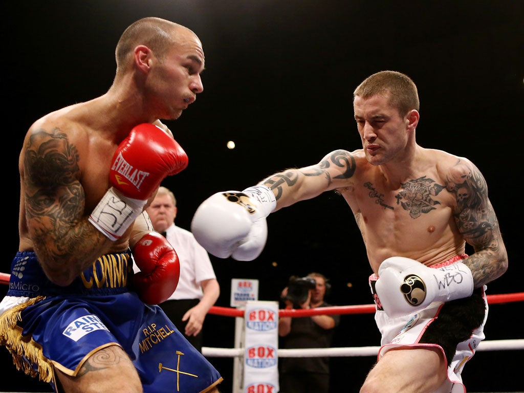 Ricky Burns (right) goes on the attack as he retains his world lightweight title in Glasgow last night