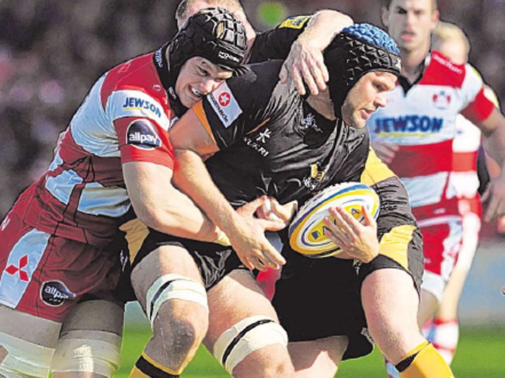 Tom Savage (left) puts in a hit on Wasps’ Tom Palmer