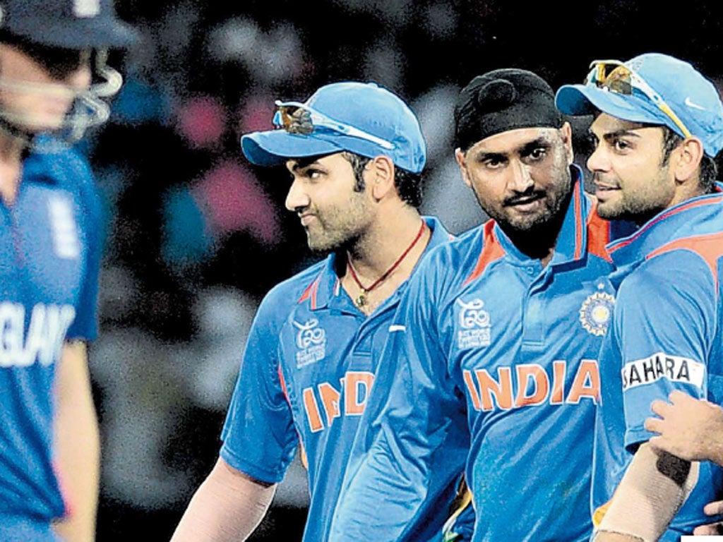 Harbhajan Singh is flanked by delighted team-mates after taking Tim Bresnan’s wicket yesterday