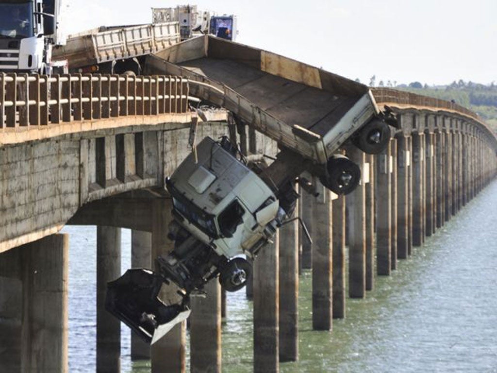The truck hangs from the Chavantes bridge near Fartura, southern Brazil
