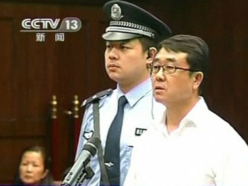 Ex-police chief Wang Lijun reads a statement during his sentencing inside the courtroom of the Chengdu