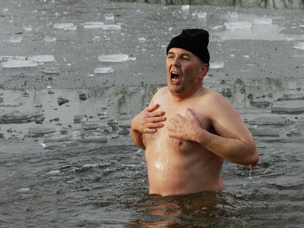 A member of the 'Polar Wolfs' club goes skinny dipping in the ice cold water in a lake near the eastern German town of Zehdenick 26 December 2007.