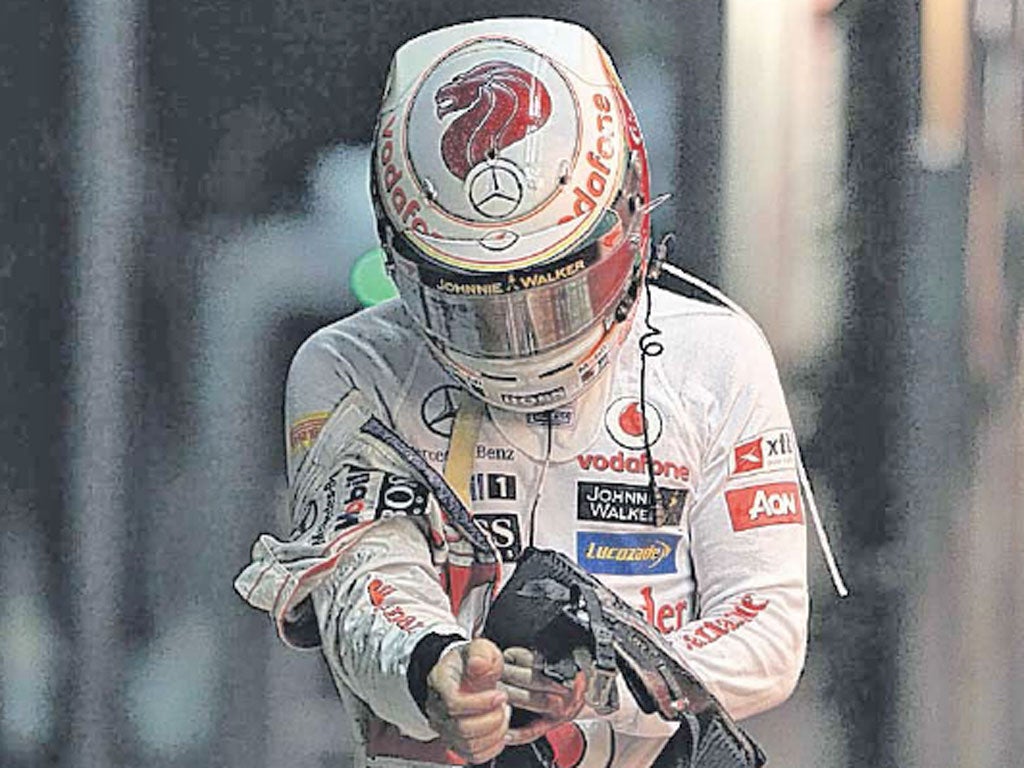Lewis Hamilton heads to the paddock after his car suffered engine failure