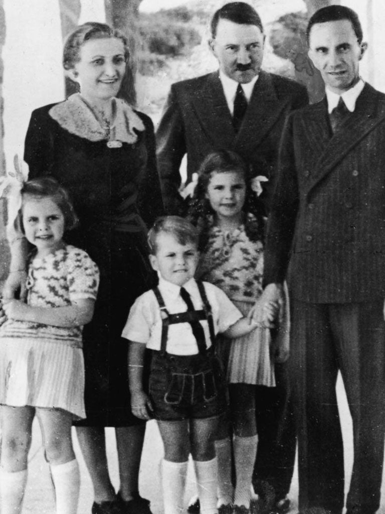 Genocidal German dictator and Nazi leader Adolf Hitler (1889 - 1945), centre, stands with Nazi Propaganda Minister Joseph Goebbels, his wife Magda and their three oldest children, left to right, Hilda, Helmut, and Helga