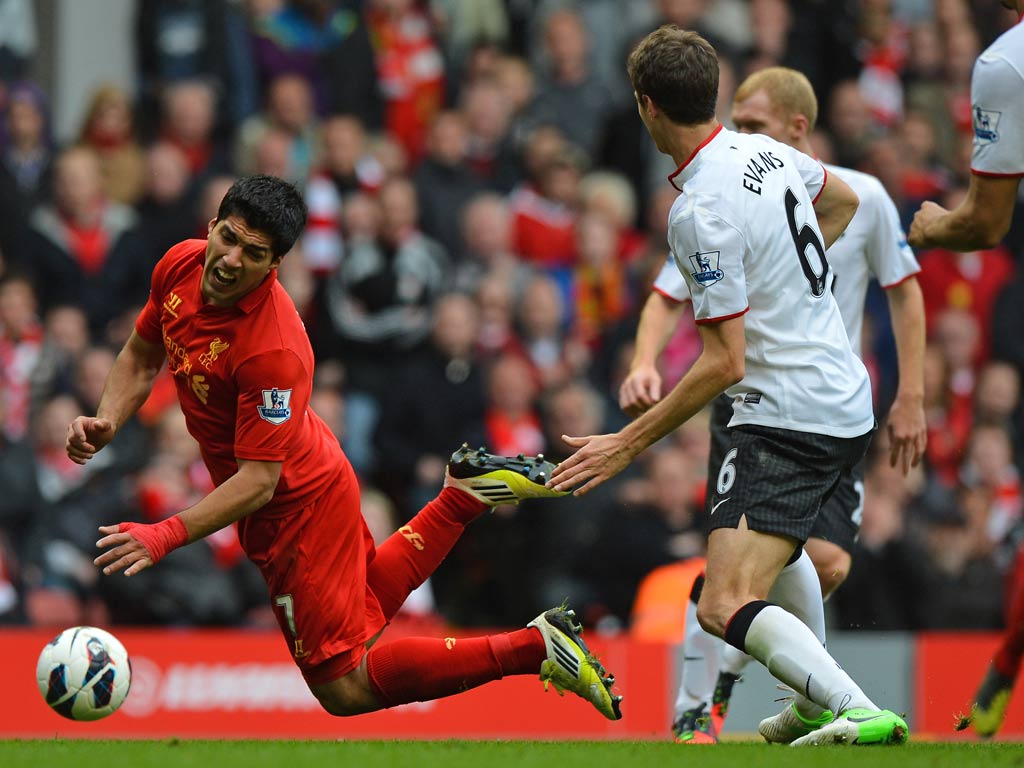 Luis Suarez takes a tumble against Manchester United