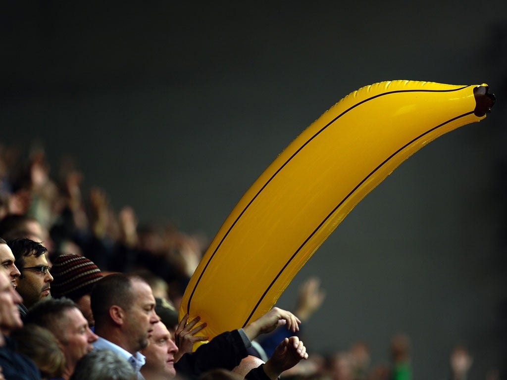 An inflatable banana emerges from the crowd during Manchester City's football match against Wigan Athletic on September 19, 2010.