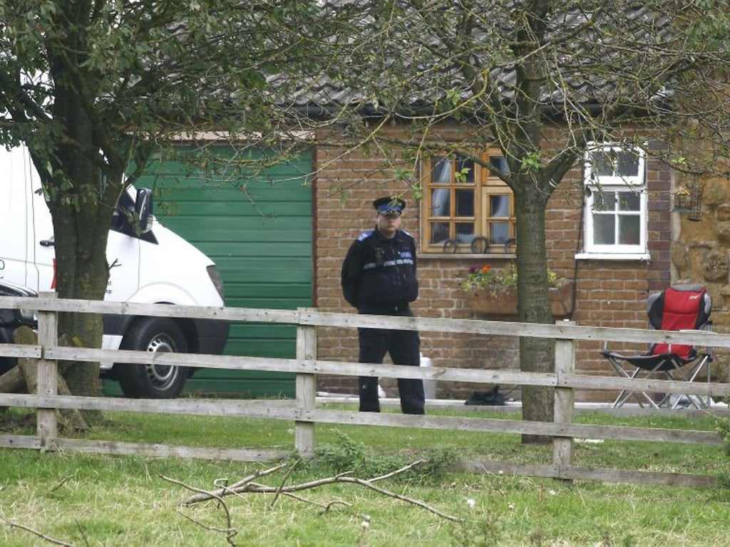 Police outside wait outside the farmhouse in Welby earlier this month