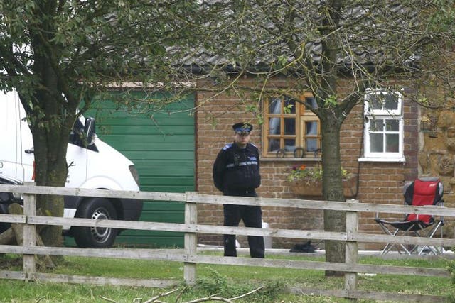 Police outside wait outside the farmhouse in Welby earlier this month