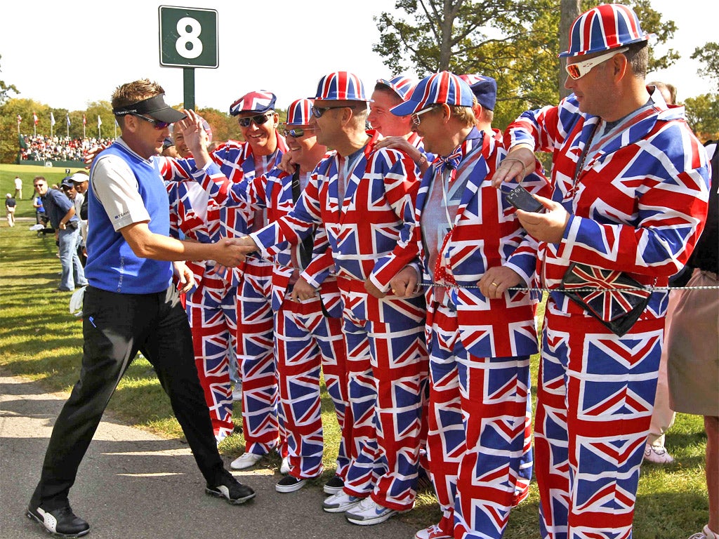 Ian Poulter greets a group of partisan fans at Medinah yesterday
