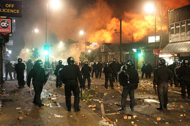 Police officers on riot duty in Tottenham in the violent aftermath of the shooting of Mark Duggan