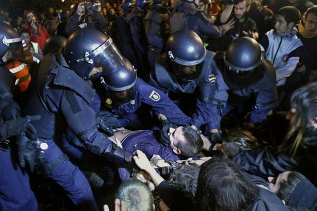Police clash with protesters in Madrid during a demonstration against austerity measures announced by the Spanish government