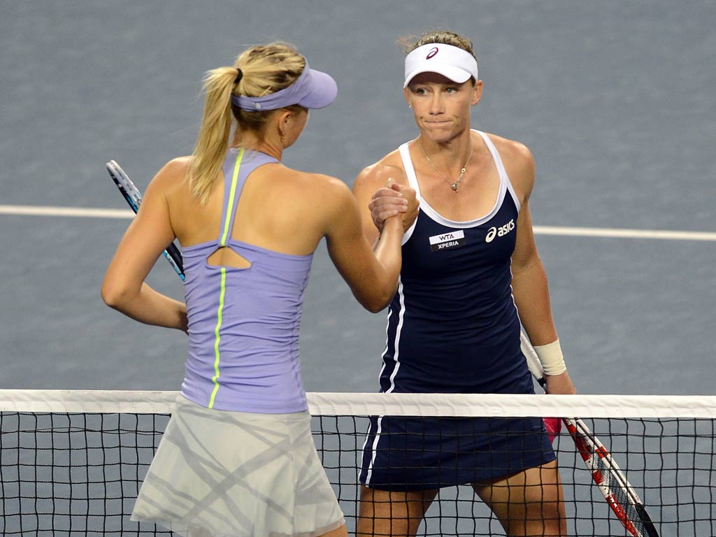Samantha Stosur (R) of Australia is congratulated on her victory by Maria Sharapova