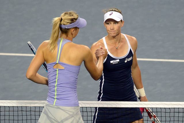 Samantha Stosur (R) of Australia is congratulated on her victory by Maria Sharapova 