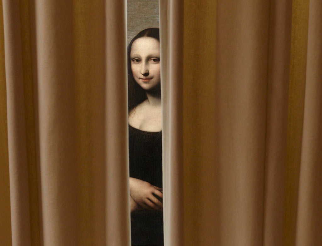 Another Mona Lisa? A painting attributed to Leonardo da Vinci and representing Mona Lisa is pictured behind a curtain during a preview presentation in a vault in Geneva September 26, 2012.