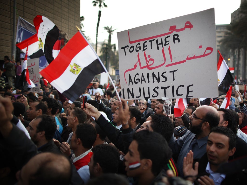 People in Tahrir Square take part in a mass rally calling for an end to military rule IN Cairo, 2011.