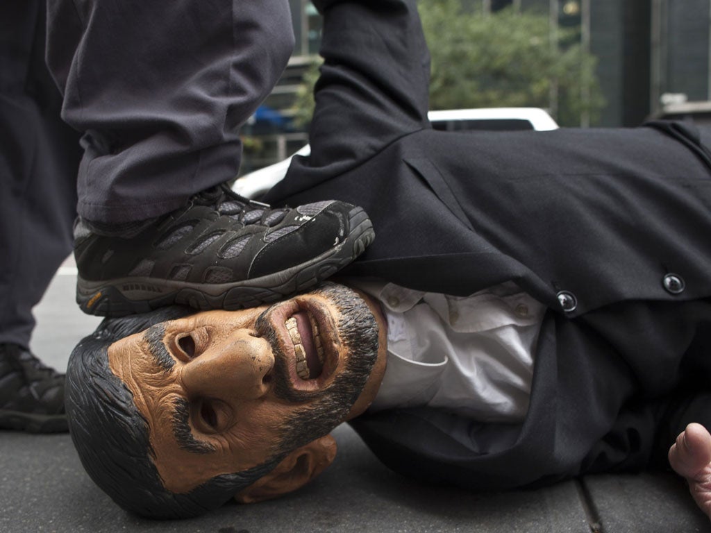 A human rights activist opposed to Tehran makes his point at the UN in New York by wearing a Mahmoud Ahmadinejad mask