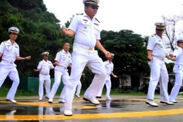 In this image made from an undated video released by Thai Royal Navy, Thai sailors perform the rodeo-style dance and other hip-shaking moves at their base on the popular tourist island of Phuket, southern Thailand. 