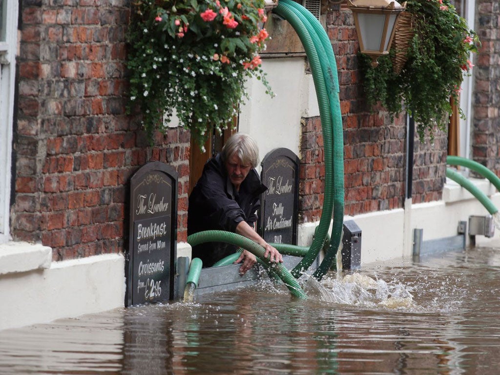 A pub landlord battles with River Ouse floodwater in York this week